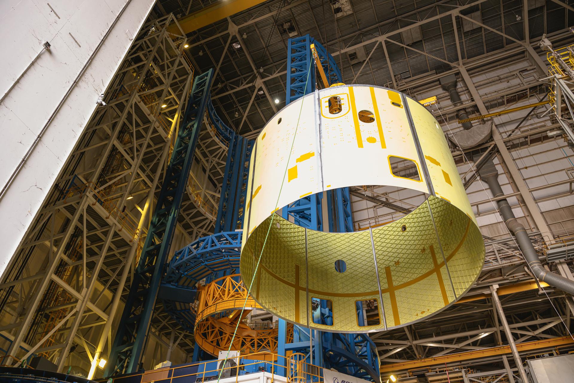 Teams at Michoud Assembly Facility in New Orleans load the engine section barrel into the vertical assembly center on Aug. 5, 2026. The engine section will be used on the SLS (Space Launch System) rocket’s core stage for the agency’s Artemis V mission. On the vertical assembly center tooling, teams will mate the flight hardware to a ring, which will serve as an attachment point for the liquid hydrogen tank later in the production process. The engine section is one of five major elements that make up the 212-foot-tall SLS rocket stage; and houses various avionic systems, the engine thrust structure, and four RS-25 engines. The core stage produces more than two million pounds of thrust to help launch NASA’s Orion spacecraft, astronauts, and supplies beyond Earth’s orbit and to the lunar surface for Artemis.